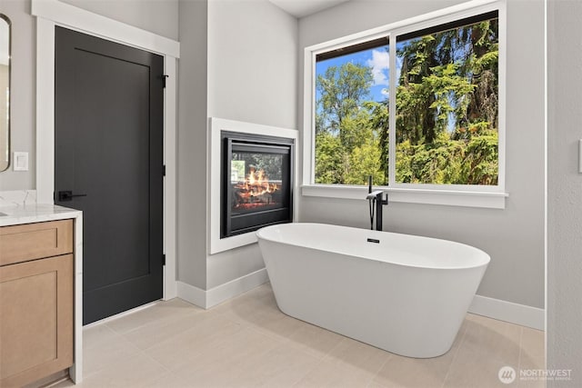 16429 Snohomish Ave SE, Clearview, WA 98296 - full bath featuring a freestanding bath, vanity, and healthy amount of natural light