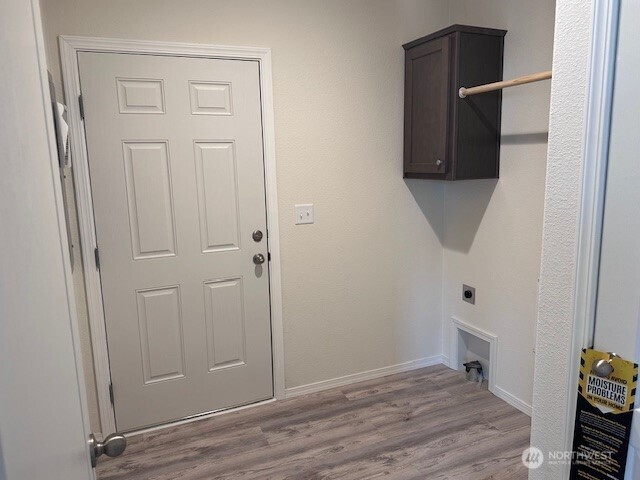2101 S 324th St Unit 193, Federal Way, WA 98003 - washroom with electric dryer hookup, cabinet space, and wood finished floors