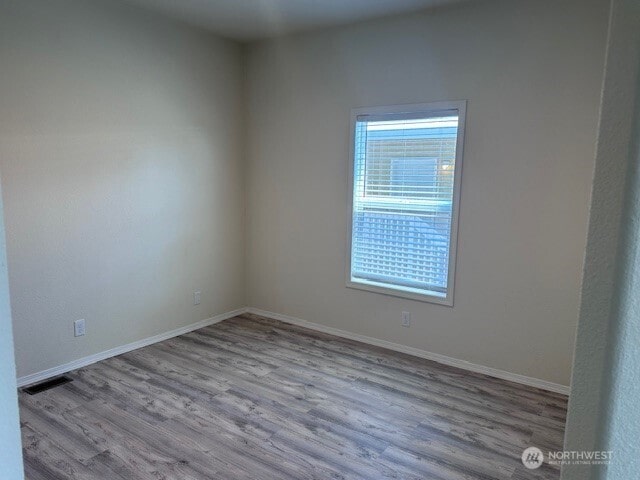 2101 S 324th St Unit 193, Federal Way, WA 98003 - empty room featuring plenty of natural light and wood finished floors