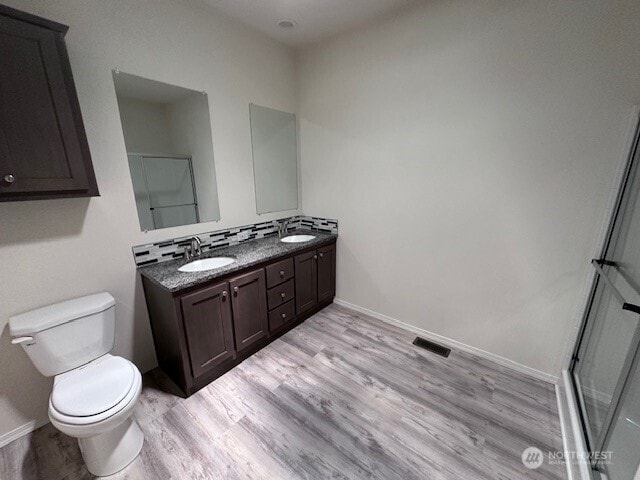 2101 S 324th St Unit 193, Federal Way, WA 98003 - bathroom with double vanity, wood finished floors, and an enclosed shower
