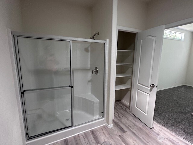 2101 S 324th St Unit 193, Federal Way, WA 98003 - bathroom with a shower stall, wood finished floors, and a spacious closet