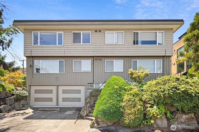3469 6th Ave W, Seattle, WA 98119 - colonial-style house with driveway, an attached garage, and stairway