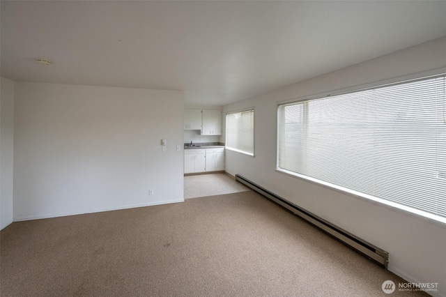 3469 6th Ave W, Seattle, WA 98119 - spare room with baseboard heating, light carpet, and a smoke detector