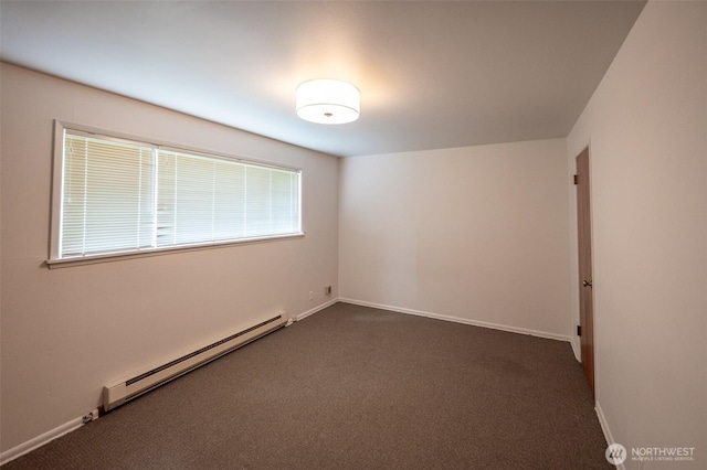 3469 6th Ave W, Seattle, WA 98119 - spare room featuring a baseboard heating unit and dark colored carpet
