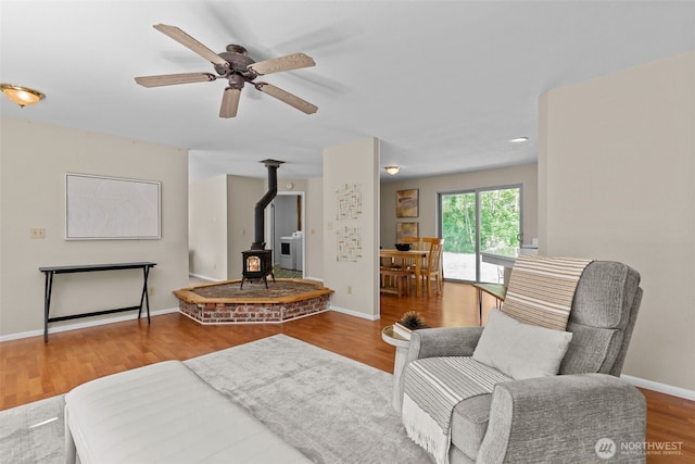 8618 212th St NE, Arlington, WA 98223 - living area featuring a wood stove, ceiling fan, and wood finished floors