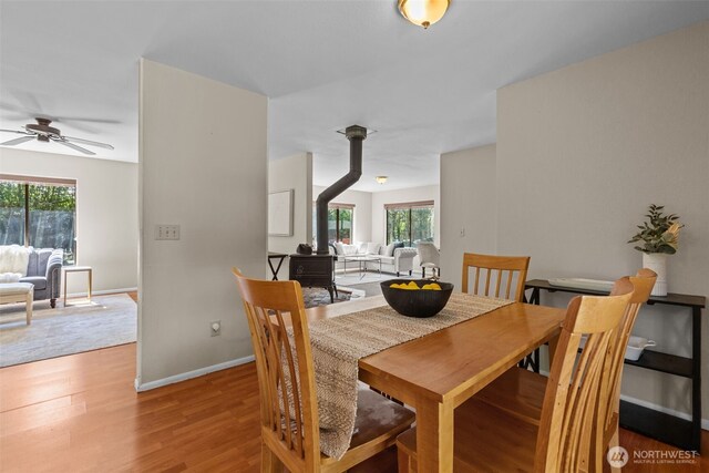 8618 212th St NE, Arlington, WA 98223 - dining space with a wood stove, a ceiling fan, plenty of natural light, and wood finished floors