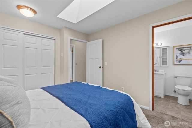 8618 212th St NE, Arlington, WA 98223 - carpeted bedroom featuring a skylight, connected bathroom, and a closet