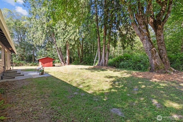 8618 212th St NE, Arlington, WA 98223 - view of grassy yard with a shed and a patio