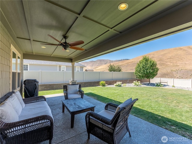 2038 Maiden Ln, Wenatchee, WA 98801 - fenced backyard featuring a mountain view, ceiling fan, and a patio