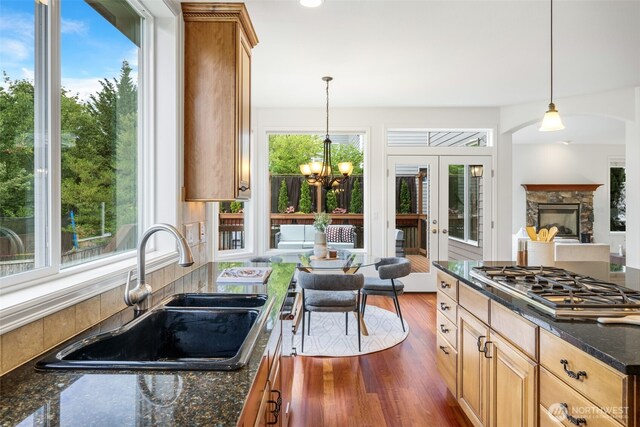 108 239th Way SE, Sammamish, WA 98074 - kitchen with stainless steel gas stovetop, a chandelier, hanging light fixtures, and dark wood-style floors