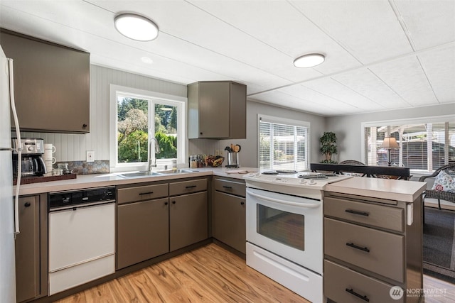 1841 Trosper Rd SW Unit 24, Tumwater, WA 98512 - kitchen featuring white appliances, gray cabinetry, a peninsula, and light wood finished floors