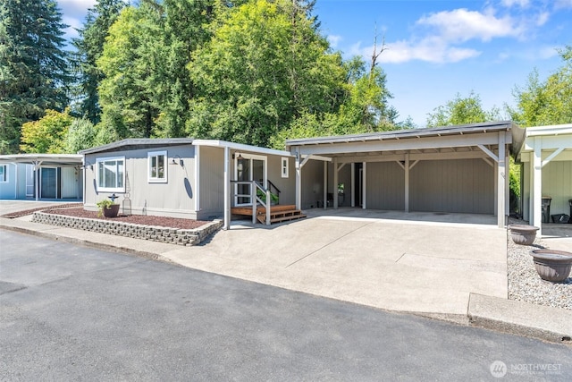 1841 Trosper Rd SW Unit 24, Tumwater, WA 98512 - view of front facade featuring concrete driveway and an attached carport