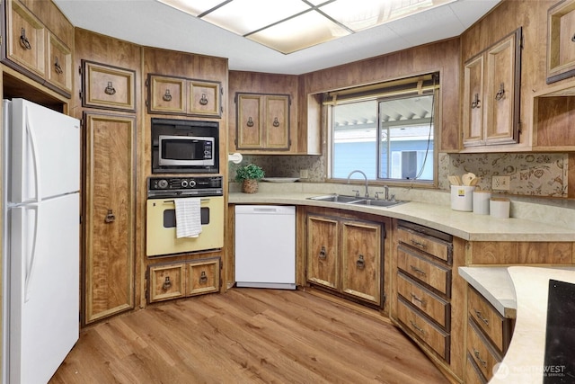 4015 Eliza Ave Unit 47, Bellingham, WA 98226 - kitchen featuring white appliances, brown cabinets, decorative backsplash, and light countertops