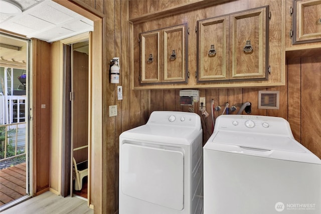 4015 Eliza Ave Unit 47, Bellingham, WA 98226 - laundry area with cabinet space, washing machine and clothes dryer, wooden walls, and wood finished floors