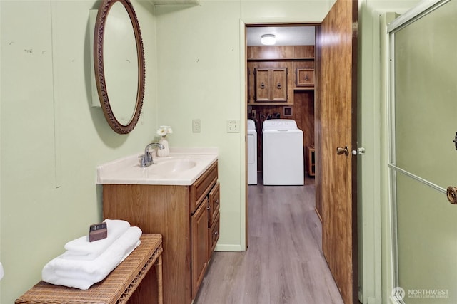 4015 Eliza Ave Unit 47, Bellingham, WA 98226 - bathroom with washer and dryer, vanity, and wood finished floors