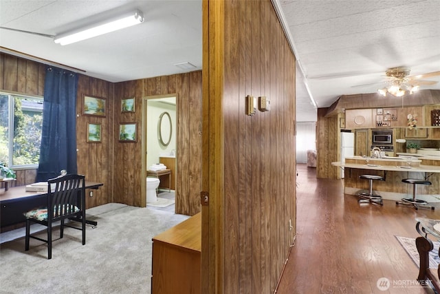 4015 Eliza Ave Unit 47, Bellingham, WA 98226 - office featuring wooden walls, ceiling fan, and wood finished floors