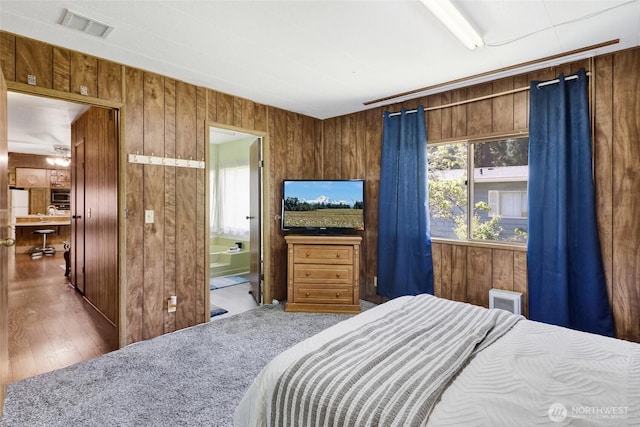 4015 Eliza Ave Unit 47, Bellingham, WA 98226 - bedroom with wooden walls, ensuite bath, and wood finished floors