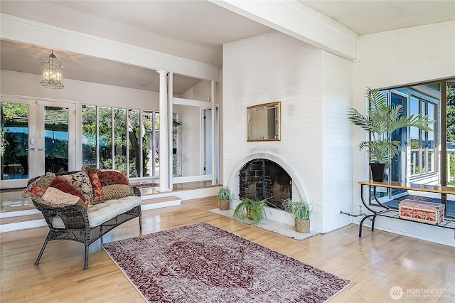 3719 NE 145th St, Seattle, WA 98155 - living area with french doors, wood finished floors, a fireplace, and healthy amount of natural light