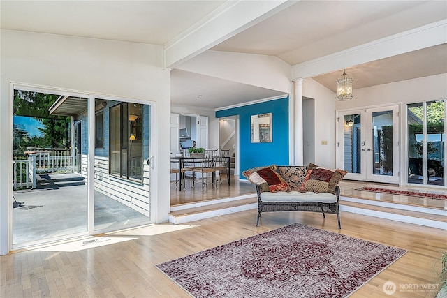 3719 NE 145th St, Seattle, WA 98155 - living room with wood finished floors, vaulted ceiling, ornate columns, and french doors