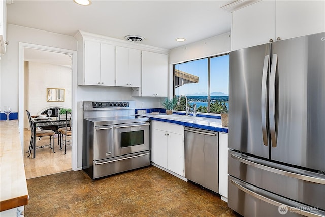 3719 NE 145th St, Seattle, WA 98155 - kitchen with appliances with stainless steel finishes, white cabinets, light countertops, recessed lighting, and a mountain view