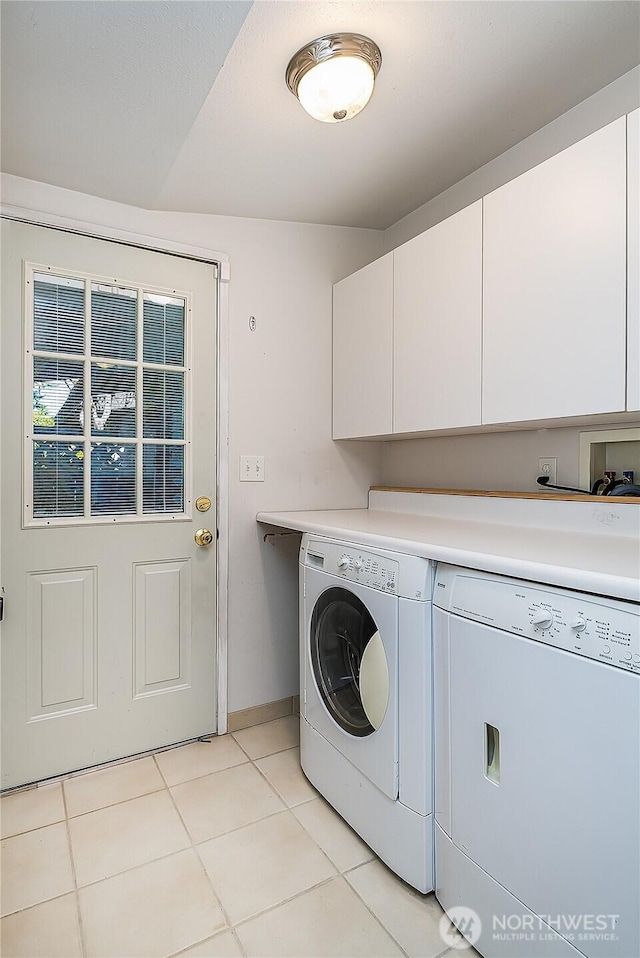 3719 NE 145th St, Seattle, WA 98155 - laundry area with cabinet space, washing machine and dryer, and light tile patterned floors