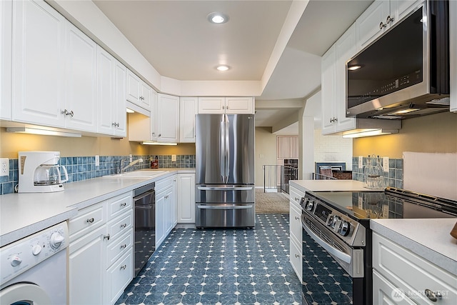 3719 NE 145th St, Seattle, WA 98155 - kitchen featuring stainless steel appliances, washer / clothes dryer, light countertops, backsplash, and recessed lighting