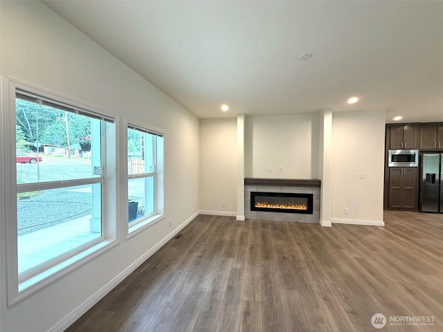 45332 Limestone St, Concrete, WA 98237 - unfurnished living room with dark wood finished floors, recessed lighting, and a tiled fireplace