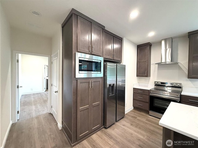 45332 Limestone St, Concrete, WA 98237 - kitchen with appliances with stainless steel finishes, wall chimney exhaust hood, light wood finished floors, dark brown cabinets, and recessed lighting