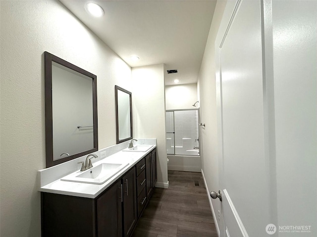 45332 Limestone St, Concrete, WA 98237 - bathroom featuring double vanity, wood finished floors, bathing tub / shower combination, and recessed lighting
