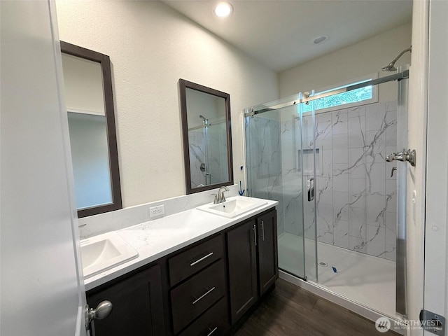 45332 Limestone St, Concrete, WA 98237 - bathroom featuring a marble finish shower, double vanity, and wood finished floors