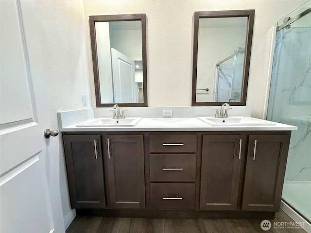 45332 Limestone St, Concrete, WA 98237 - bathroom with a marble finish shower, double vanity, and wood finished floors