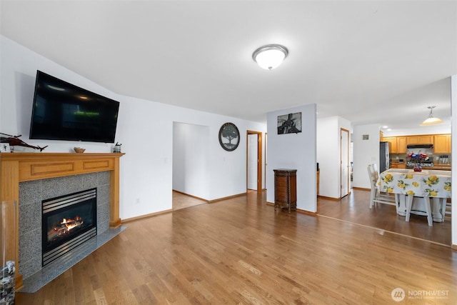 1877 Emerald Way, Lynden, WA 98264 - living area with light wood-style floors and a tile fireplace