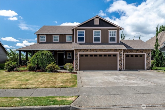 1877 Emerald Way, Lynden, WA 98264 - craftsman house featuring concrete driveway, a front lawn, stone siding, and an attached garage