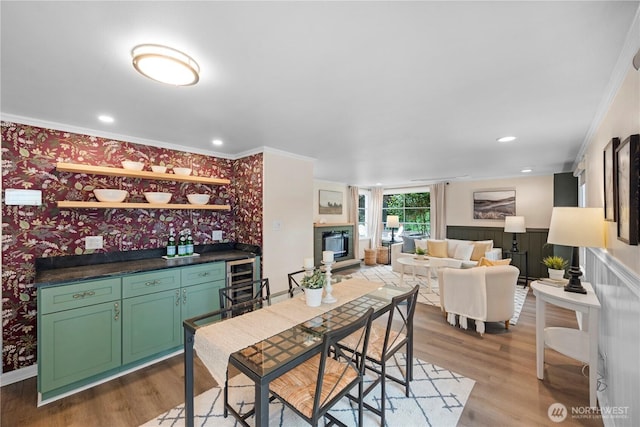 18328 15th Pl NE, Shoreline, WA 98155 - dining area with ornamental molding, wet bar, wood finished floors, wallpapered walls, and beverage cooler