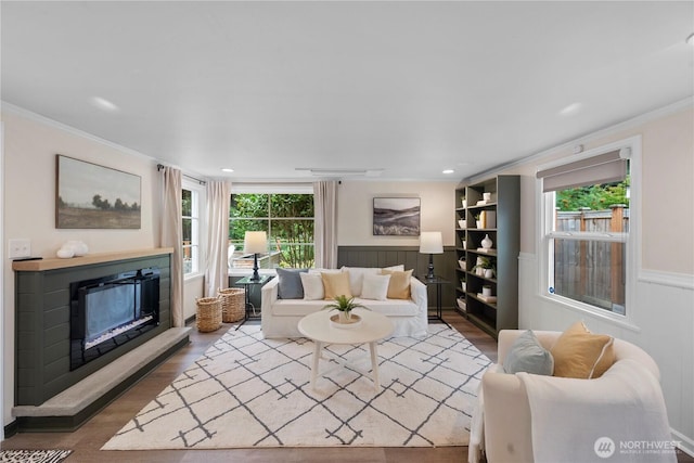 18328 15th Pl NE, Shoreline, WA 98155 - living area featuring crown molding, wood finished floors, a wainscoted wall, a glass covered fireplace, and recessed lighting
