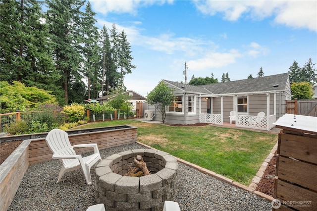 18328 15th Pl NE, Shoreline, WA 98155 - back of house with a fire pit, a fenced backyard, roof with shingles, and a vegetable garden