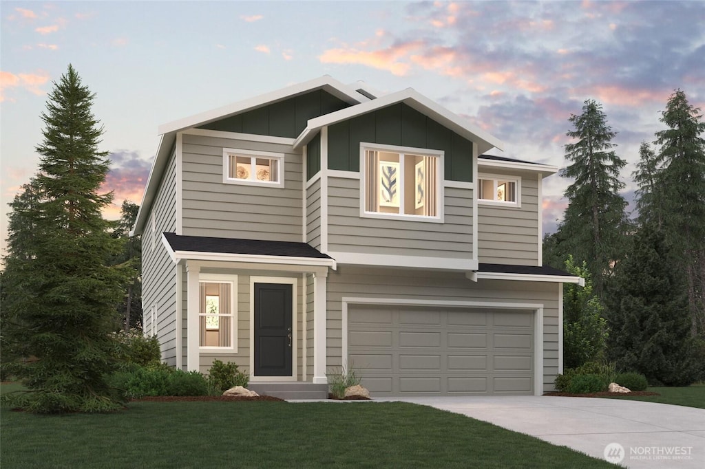 13408 324th Ave SE Unit 112, Sultan, WA 98294 - view of front of house with an attached garage, concrete driveway, a front lawn, and board and batten siding