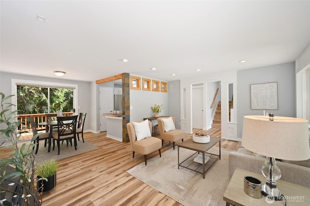 10816 NE 154th Pl, Bothell, WA 98011 - living room featuring light wood-style floors, stairs, recessed lighting, and arched walkways