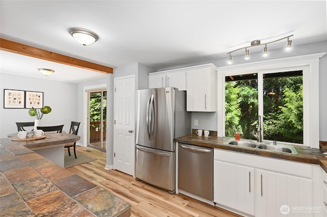 10816 NE 154th Pl, Bothell, WA 98011 - kitchen featuring stainless steel appliances, dark countertops, healthy amount of natural light, and beam ceiling