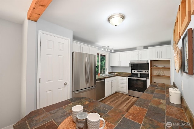 10816 NE 154th Pl, Bothell, WA 98011 - kitchen featuring appliances with stainless steel finishes, under cabinet range hood, white cabinets, tile countertops, and stone finish flooring