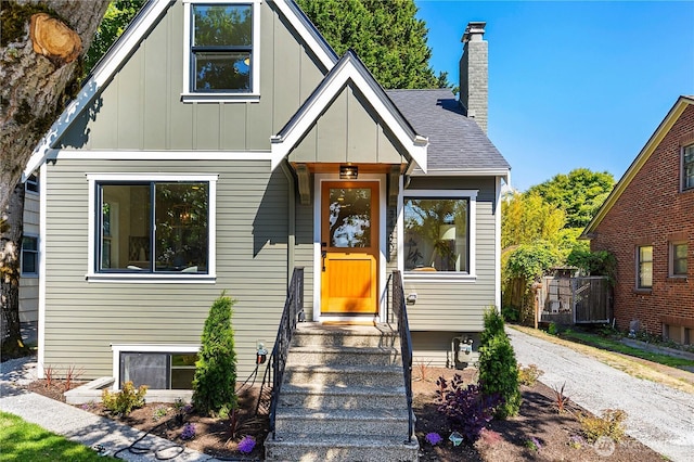 3430 42nd Ave SW, Seattle, WA 98116 - view of front of home featuring board and batten siding, a chimney, and gravel driveway