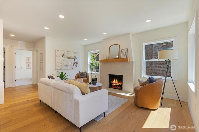 3430 42nd Ave SW, Seattle, WA 98116 - living room featuring a lit fireplace, light wood-style floors, and recessed lighting
