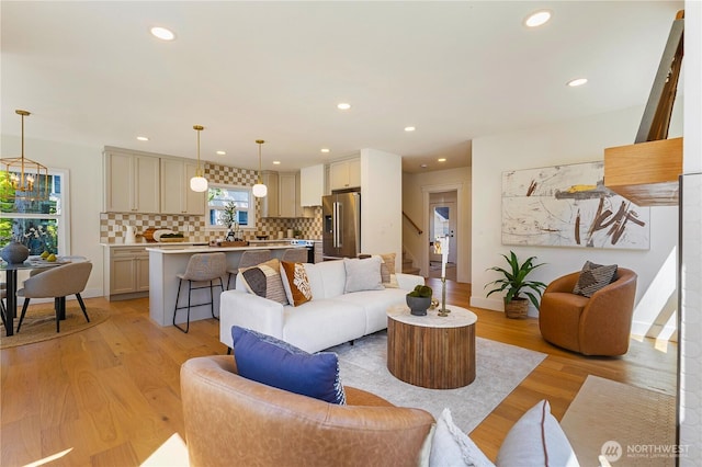3430 42nd Ave SW, Seattle, WA 98116 - living room with light wood-style flooring, recessed lighting, a chandelier, and stairway