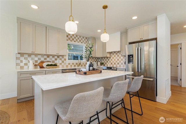 3430 42nd Ave SW, Seattle, WA 98116 - kitchen with appliances with stainless steel finishes, decorative backsplash, light countertops, and recessed lighting