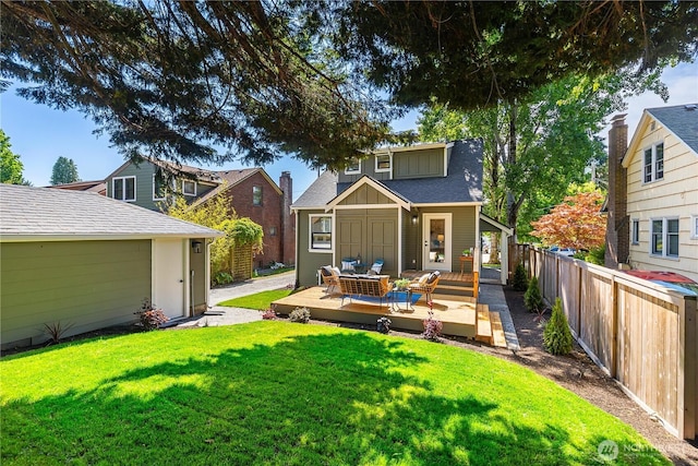 3430 42nd Ave SW, Seattle, WA 98116 - rear view of house with a wooden deck, a shingled roof, outdoor lounge area, and an outbuilding