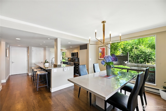 9717 NE Juanita Dr Unit 101, Kirkland, WA 98034 - dining area featuring a chandelier, dark wood finished floors, crown molding, and recessed lighting