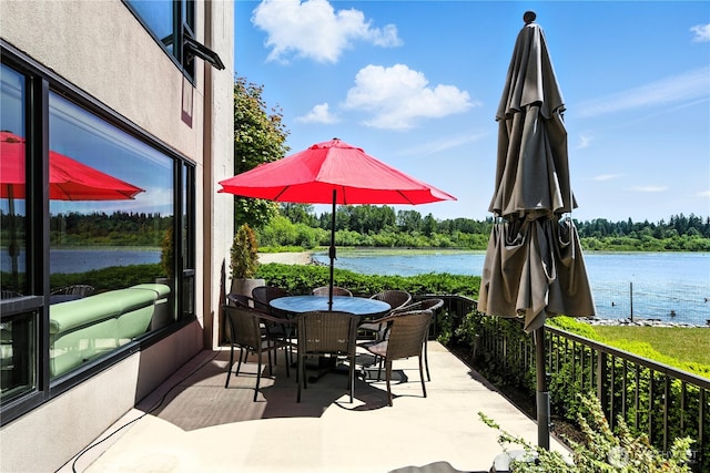 9717 NE Juanita Dr Unit 101, Kirkland, WA 98034 - view of patio / terrace featuring a water view and outdoor dining area