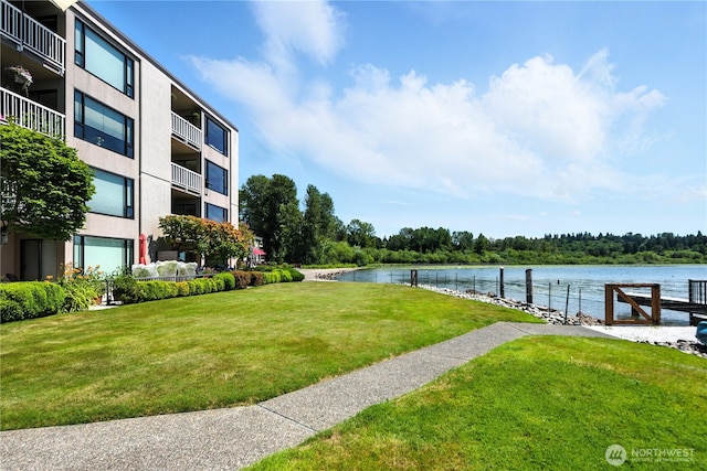 9717 NE Juanita Dr Unit 101, Kirkland, WA 98034 - dock featuring a water view and a lawn