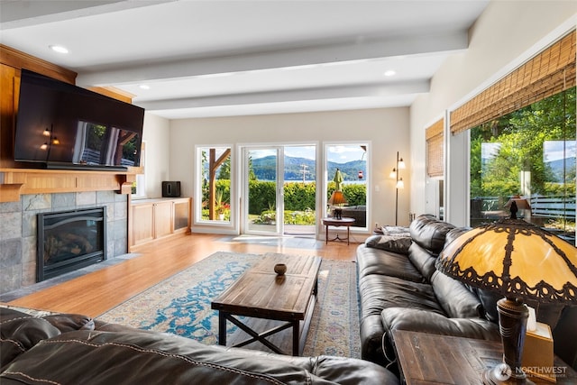 3319 Sunny Cove Ct, Bellingham, WA 98226 - living area with beamed ceiling, wood finished floors, a fireplace, a mountain view, and recessed lighting