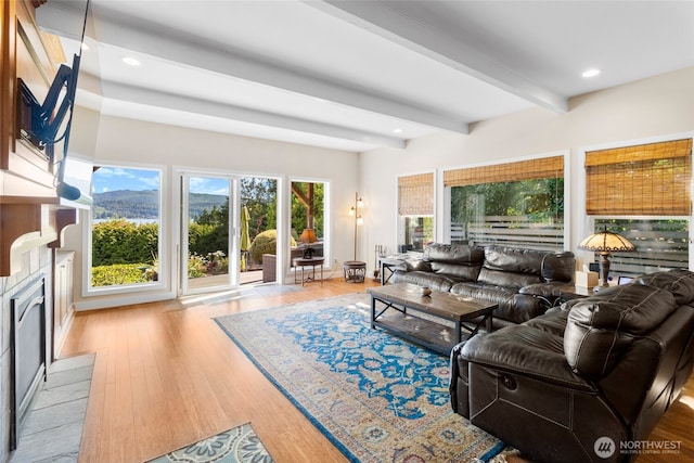 3319 Sunny Cove Ct, Bellingham, WA 98226 - living area featuring beamed ceiling, wood finished floors, a fireplace with flush hearth, and recessed lighting